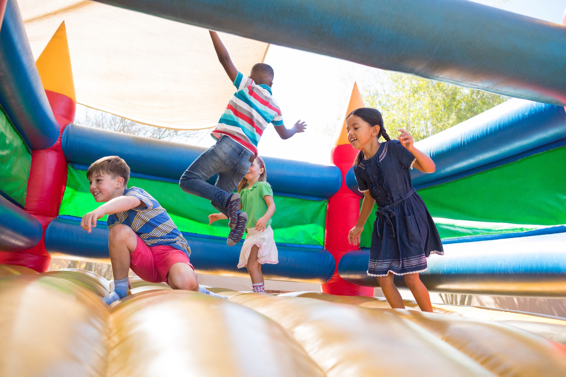 Friends jumping on bouncy castle
