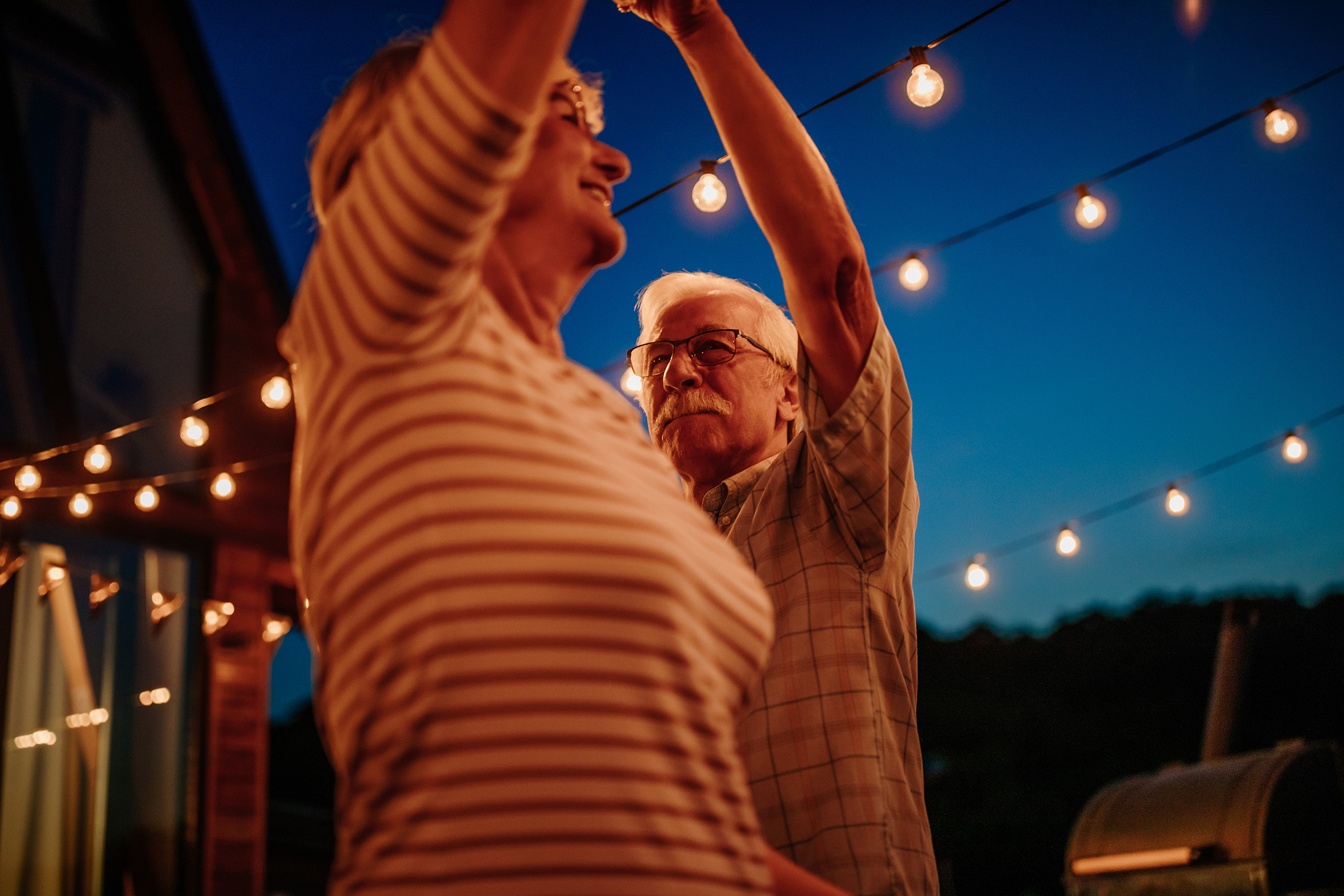 Happy senior couple dancing together outdoors